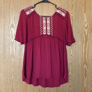 Burgundy blouse with white lace accents